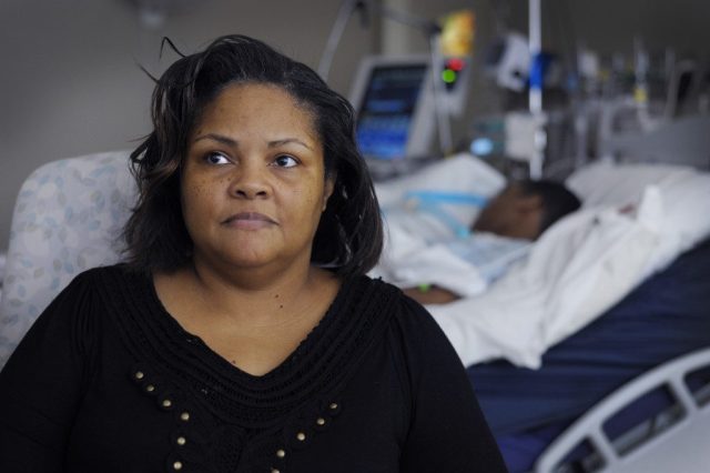 Zondra Magness sits in the hospital room with her son Monroe Bird III "Trey" at the Kaiser Rehabilitation Center in Tulsa, OK. Tuesday May 12, 2015. Bird was shot and paralyzed by a security guard in the parking lot of the Deerfield Estates Apartments when Bird was spotted in the car with a girl earlier this year. Photo by Brandi Simons for The Frontier. Zondra Magness sits in the hospital room with her son Monroe Bird III "Trey" at the Kaiser Rehabilitation Center in Tulsa, OK. Tuesday May 12, 2015. Bird was shot and paralyzed by a security guard in the parking lot of the Deerfield Estates Apartments when Bird was spotted in the car with a girl earlier this year. Photo by Brandi Simons for The Frontier.